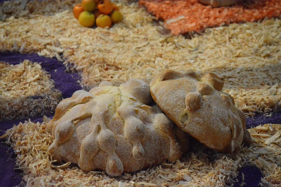 Pan de muerto on an altar — local bakeries sell it in late October