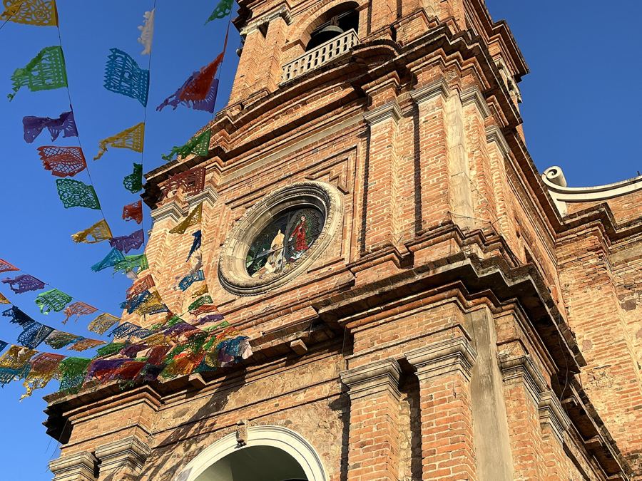 Papel picado over the Church of Our Lady of Guadalupe